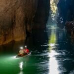 Sungai bawah tanah gua Batulubang Bokimoruru yang mengalir keluar melalui mulut gua. (Foto : Azizfardhani via Forest Watch Indonesia)